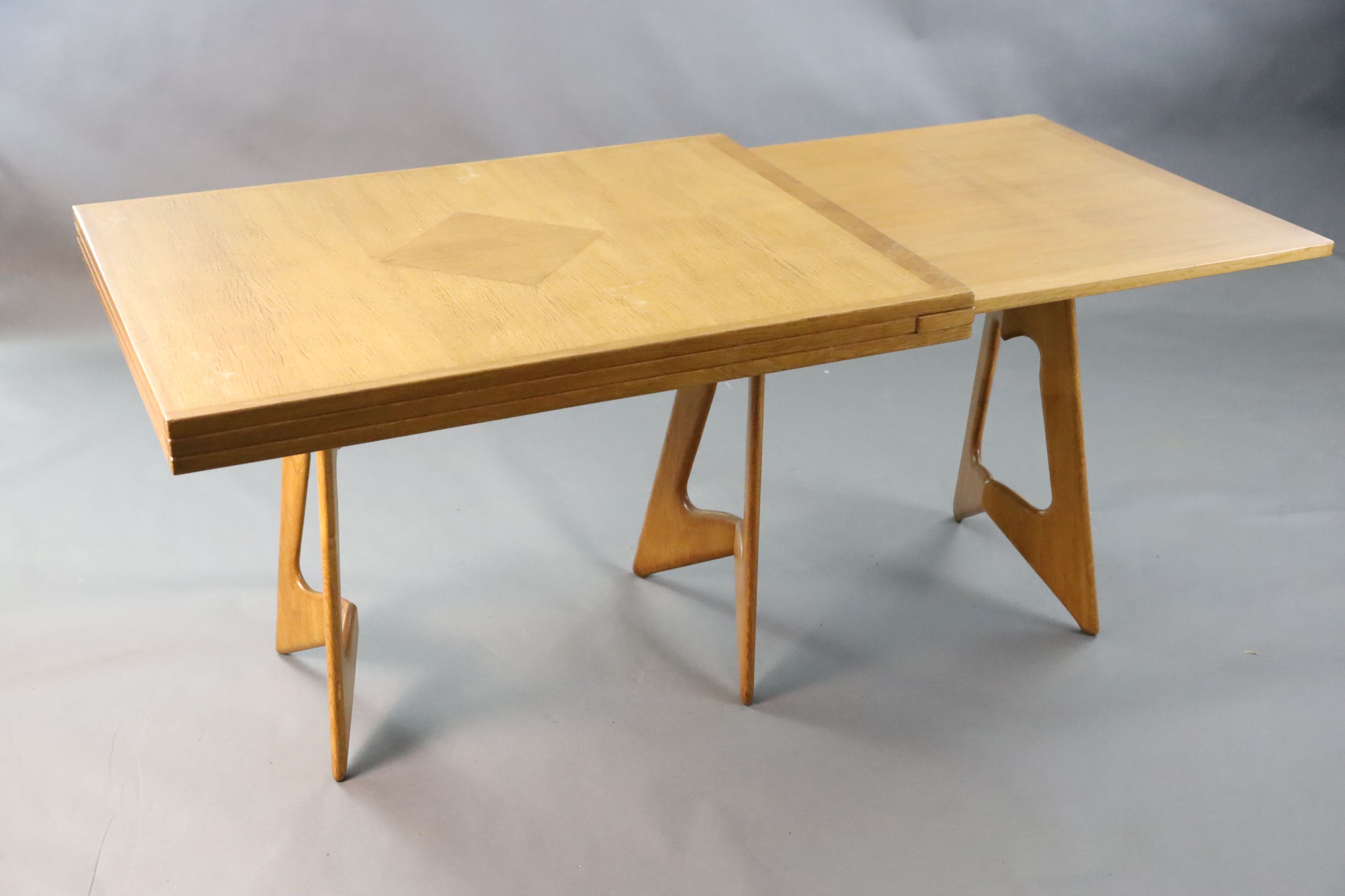A Guillerme & Chambron golden oak draw leaf dining table, W.3ft 7in. D.2ft 9in. when closed, H.2ft 5in.